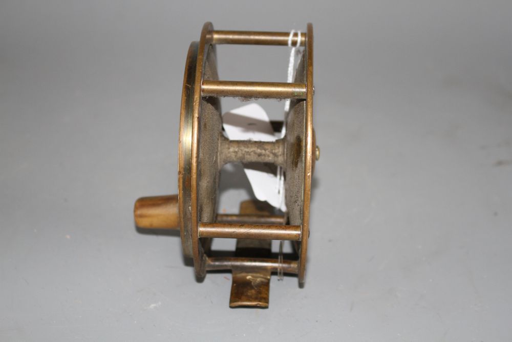 An early brass 4.5in. fishing reel by Army & Navy Cooperative Stores Ltd., engraved mark, diameter 11.5in., with horn handle